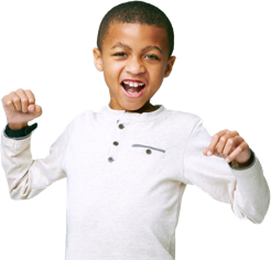 EXONDYS 51 patient Xavier, age 10, standing with fists up smiling and looking at camera